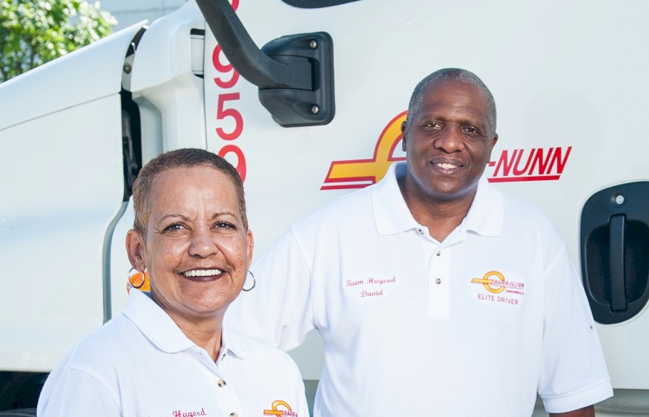 Two Barr-Nunn Transportation drivers standing in front of a company truck, Become a Team Driver