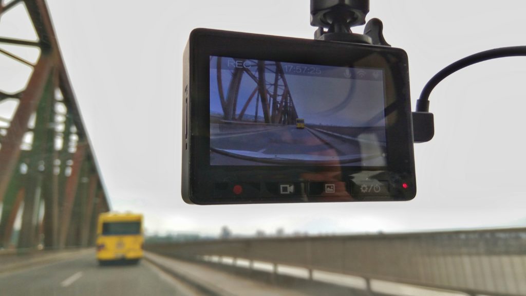 View of a truck from the inside showing a dashcam over a highway, dashcam for truckkers